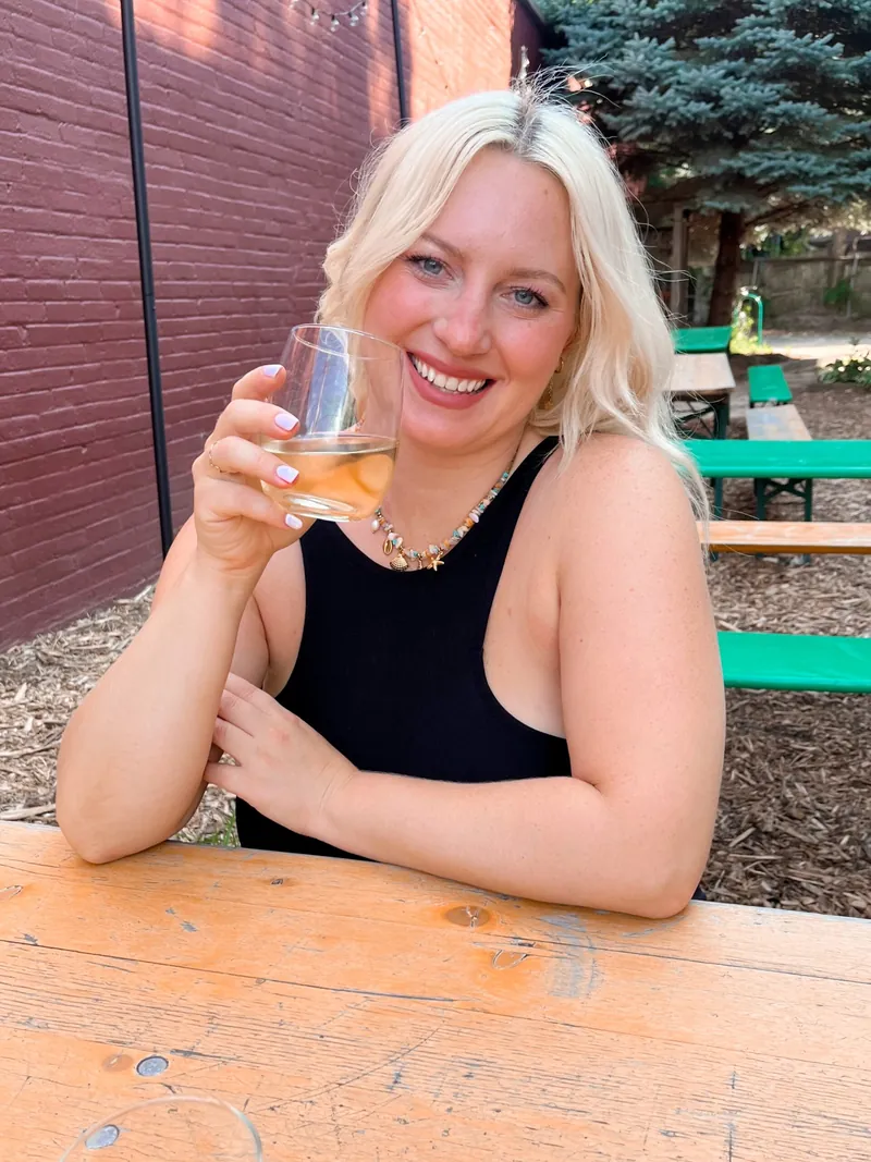 Ann Marie smiling at a picnic table