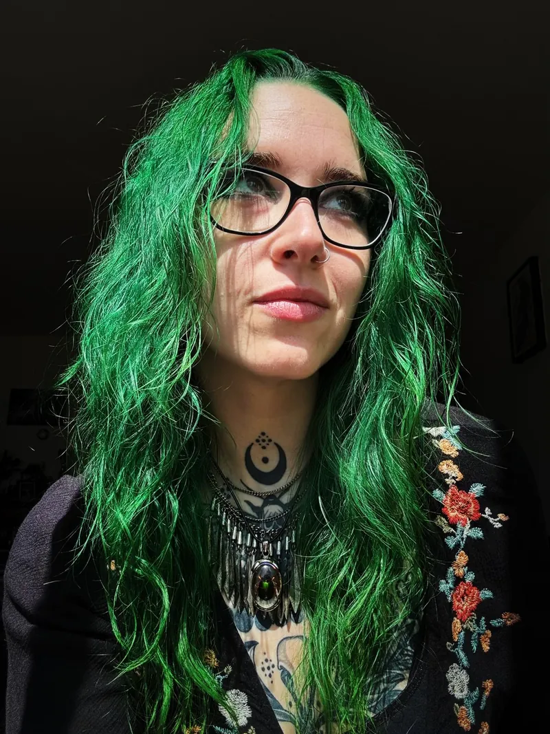Molly with bright green hair and glasses